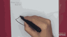 a hand is holding a black marker on a piece of paper that says draw cute things on it