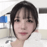 a close up of a girl 's face with her hand on her face