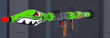 a green rocket launcher with a shark design on the barrel