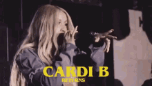 a woman singing into a microphone with the words cardi b returns in yellow letters