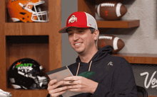 a man wearing a red and white ohio state hat