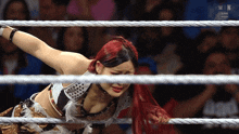 a woman in a wrestling ring with the letters n on the ropes