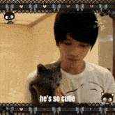 a man holding a cat that says he 's so cutie on the bottom