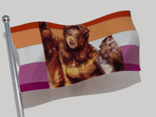 a flag with a picture of a woman on it is waving in the wind