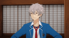 a boy with gray hair is wearing a blue jacket and red tie