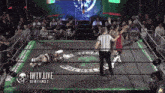 a wrestler is laying on the ground in a wrestling ring with the words iwtv live on the bottom
