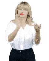 a blonde woman wearing a white shirt and black pants is making a hand gesture
