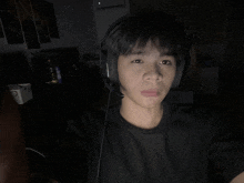 a young man wearing headphones takes a selfie