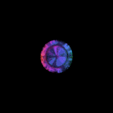 a rainbow colored circle on a black background that looks like a clock