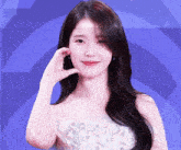 a woman in a white dress with a blue background
