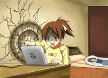 a girl wearing a yellow shirt that says okb is using a laptop computer