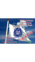 a white flag with a blue triangle on it is waving in the wind