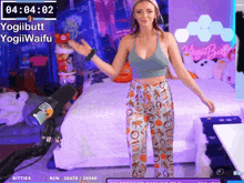 a woman is dancing in front of a screen that says yogi butt on it