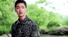 a young man in a military uniform has the letters adts on his chest