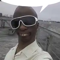 a man wearing sunglasses is taking a selfie on a wooden pier .