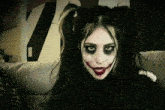 a woman with pigtails and a joker face paint on her face