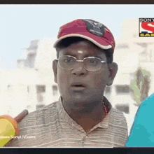 a man wearing glasses and a red hat is on a sony tv show