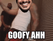 a man with a beard is smiling with the words goofy ahh written below him