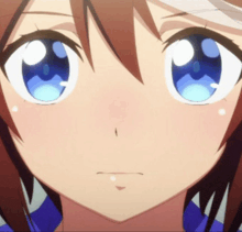 a close up of a girl 's face with blue eyes and brown hair