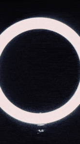 a person 's fist is in the middle of a ring of light