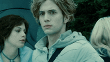 a man in a white jacket is standing next to a woman