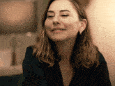 a close up of a woman 's face with a smile on her face