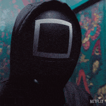 a person wearing a mask that says netflix on the bottom of it