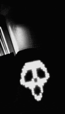 a black and white photo with a skull in the corner