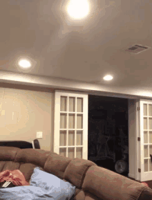 a living room with a couch and sliding doors