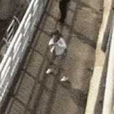 a blurry picture of a person walking down a sidewalk next to a sign .