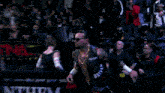a wrestler in a black shirt with the word new on the back
