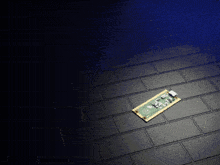 a piece of electronic equipment is laying on a black tile floor
