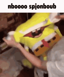 a person is holding a stuffed spongebob with the words nboooo spyonboub written above it