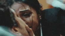 a woman is crying with a tear coming out of her eye