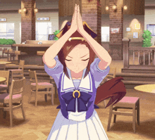 a girl in a purple and white dress is praying