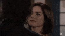 a man and woman are hugging each other in a room .