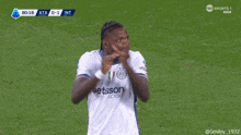 a soccer player wearing a betsson sport jersey stands on a field