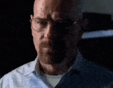 a man with a beard and glasses is talking to another man in a room .