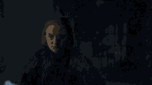 a dark room with a light shining through a window