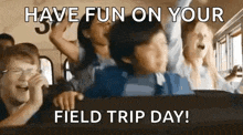 a group of children are riding on the back of a school bus and laughing .