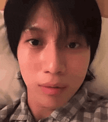 a close up of a person 's face while laying in a bed .