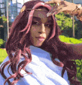 a woman with long red hair is wearing a white top