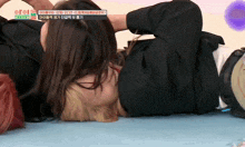 a couple of women laying on the floor with a sign above them that says ' ioi ' on it
