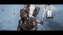 a man with a beard is holding a sword and looking at the camera