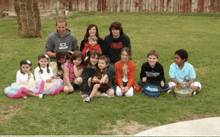 a group of children are posing for a picture and one boy is wearing a vans shirt