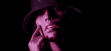 a close up of a woman 's face with her finger to her mouth