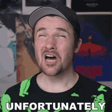 a man with his eyes closed is wearing a green sweater that says " unfortunately "