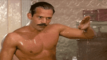 a shirtless man with a mustache is showering