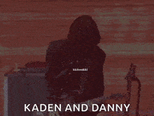 a man playing a guitar with the words kaden and danny written below him