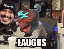 a man wearing a beanie that says blizzard laughs next to another man